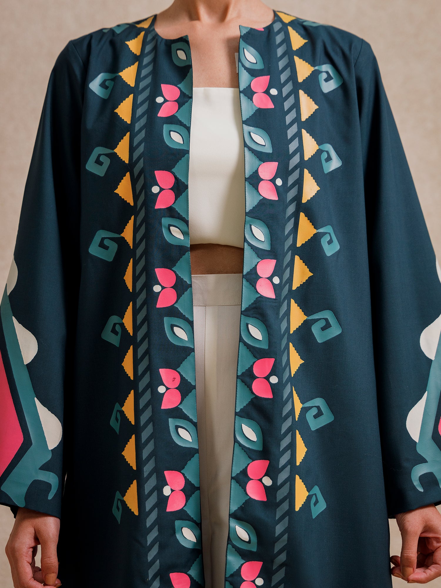 Close-up of Jade Fest Green long jacket showing hand screen-printed front motifs