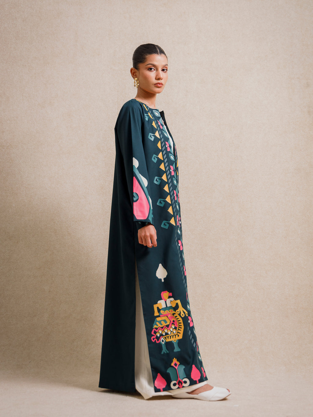 Side view of Jade Fest Green long jacket highlighting its length, drape, and screen-printed motifs