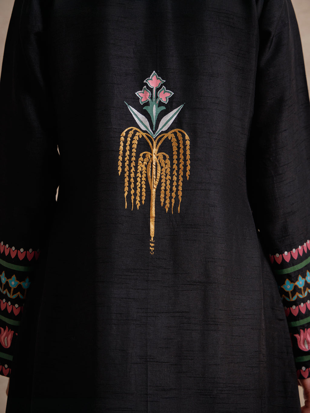 Back detail of Courtyard Dance black long jacket featuring a hand-printed floral motif inspired by traditional court gardens