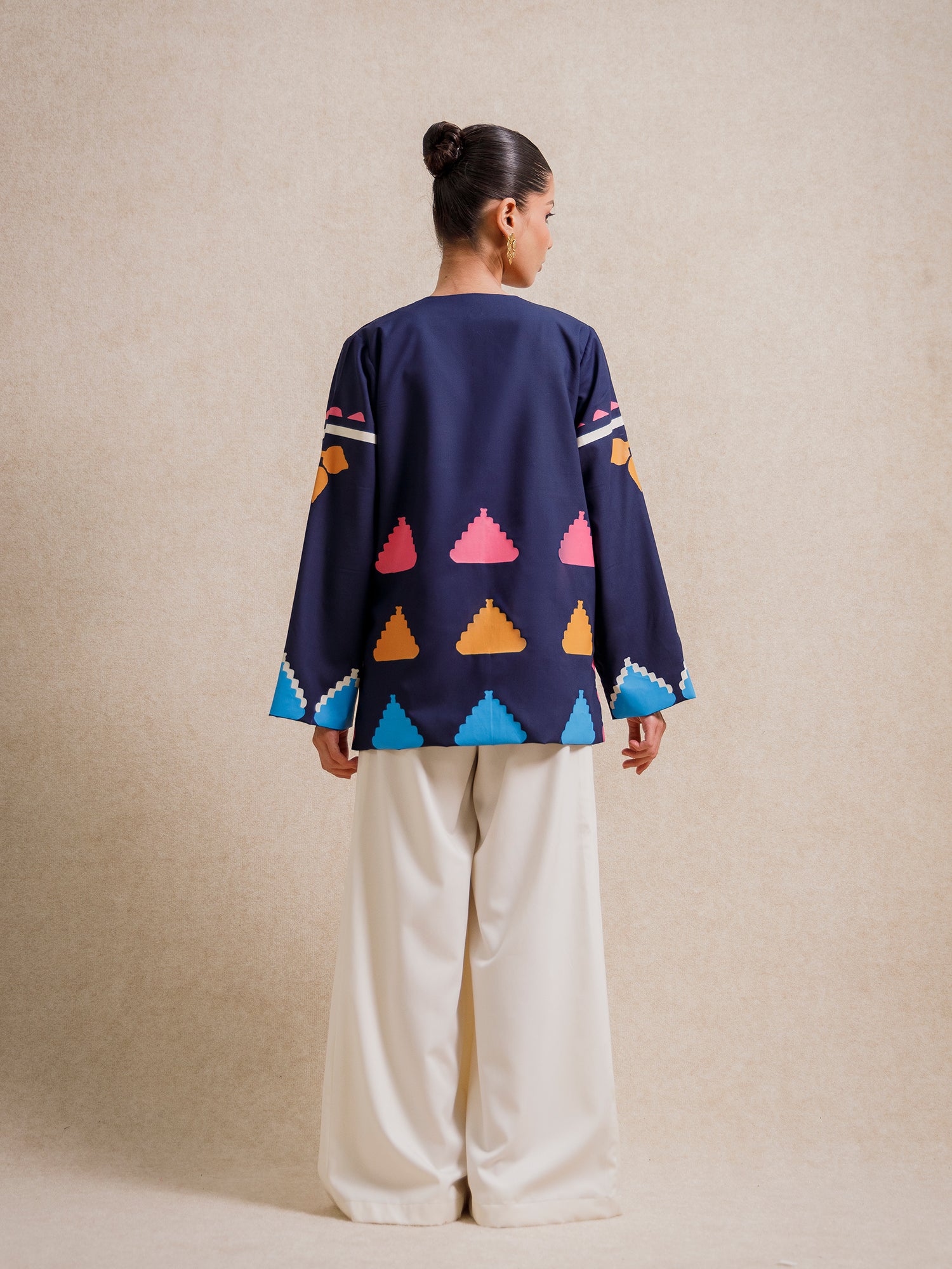 Back view of Medici Dream blue short jacket with geometric screen-printed motifs