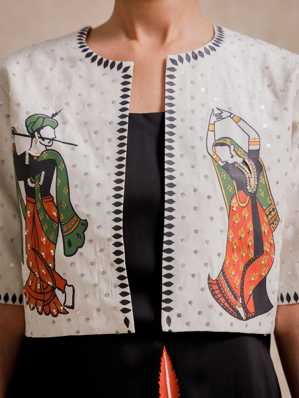 Close-up of Eternal Lovers white cropped jacket featuring hand-illustrated figures and textured embroidery details
