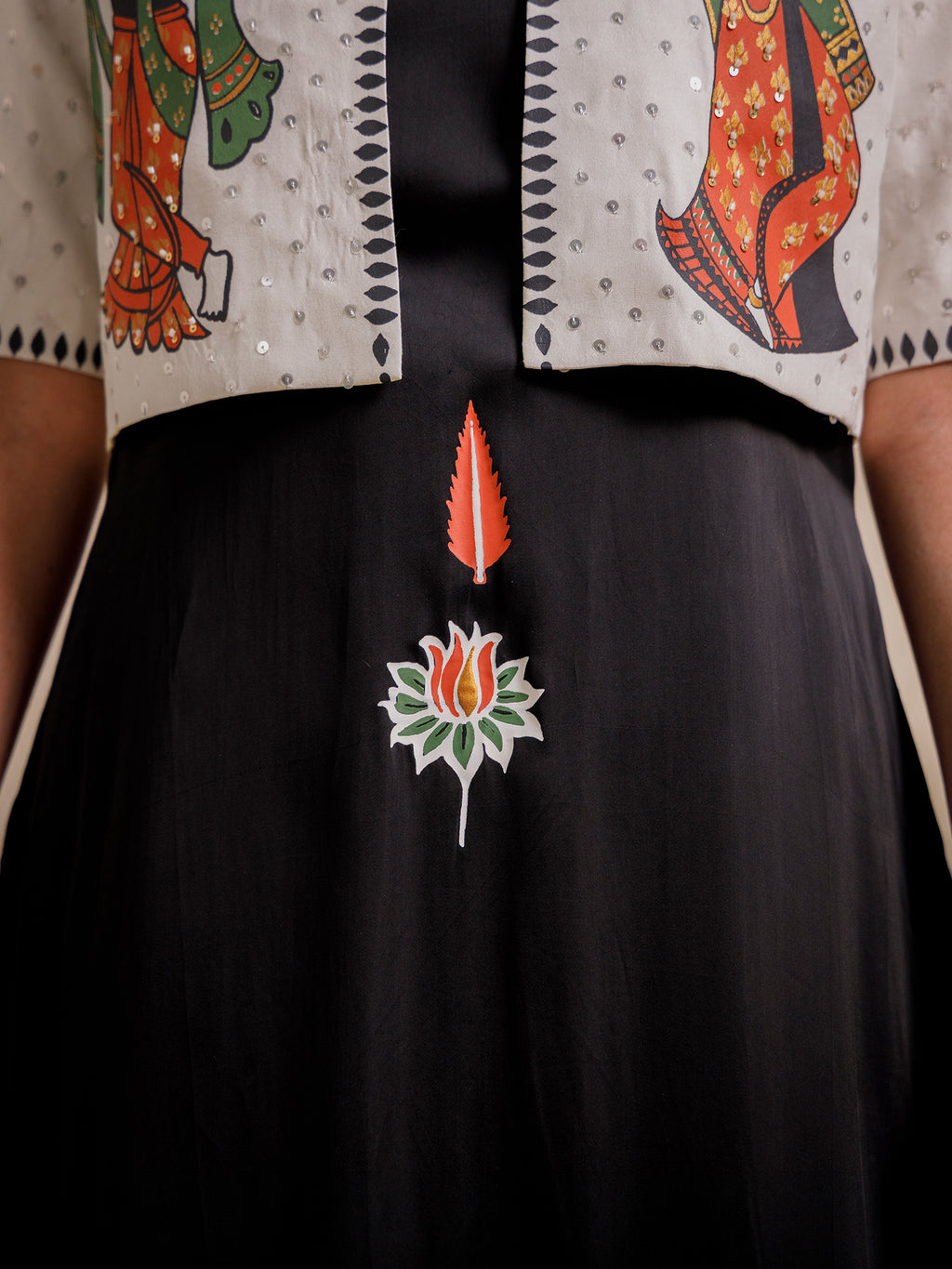 Close-up of Eternal Lovers black skirt featuring hand-illustrated floral and symbolic motif at the center