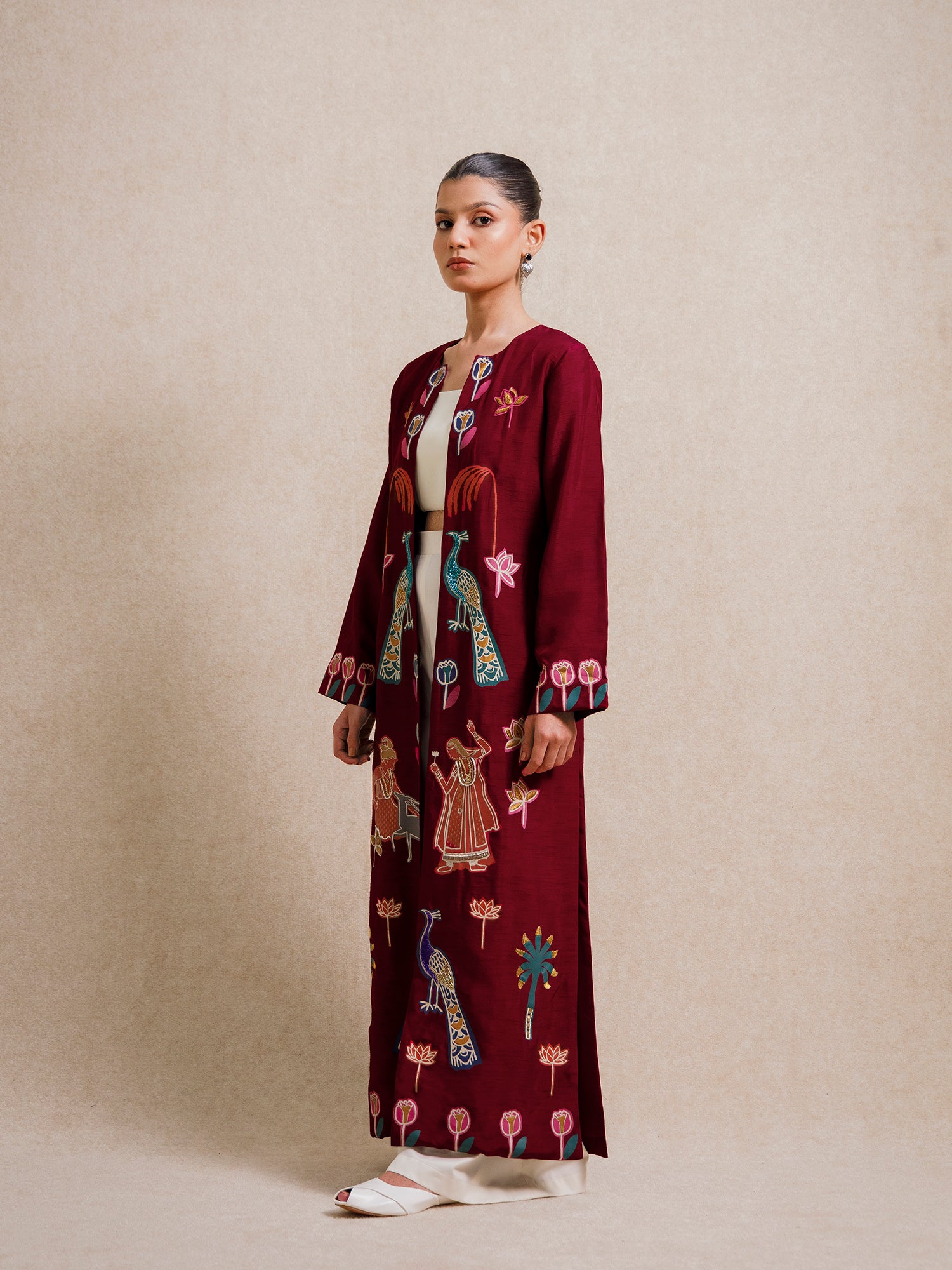 Model wearing the Forbidden Love Scarlet embroidered long jacket from Rangdasti, shown in a side profile