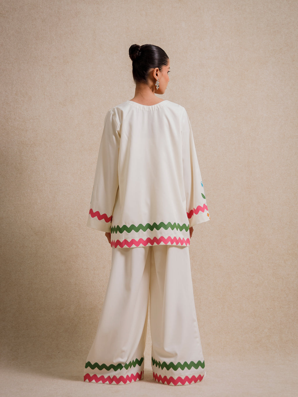 Back view of the Ivory Court two piece set featuring scalloped hem detailing on ivory fabric