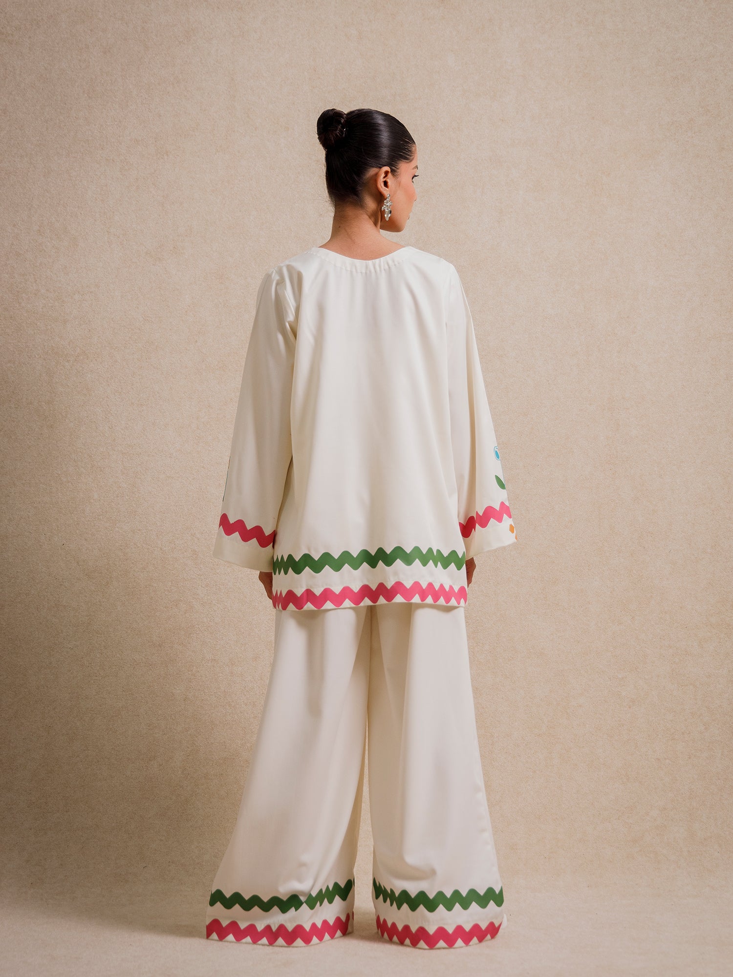 Back view of the Ivory Court two piece set featuring scalloped hem detailing on ivory fabric