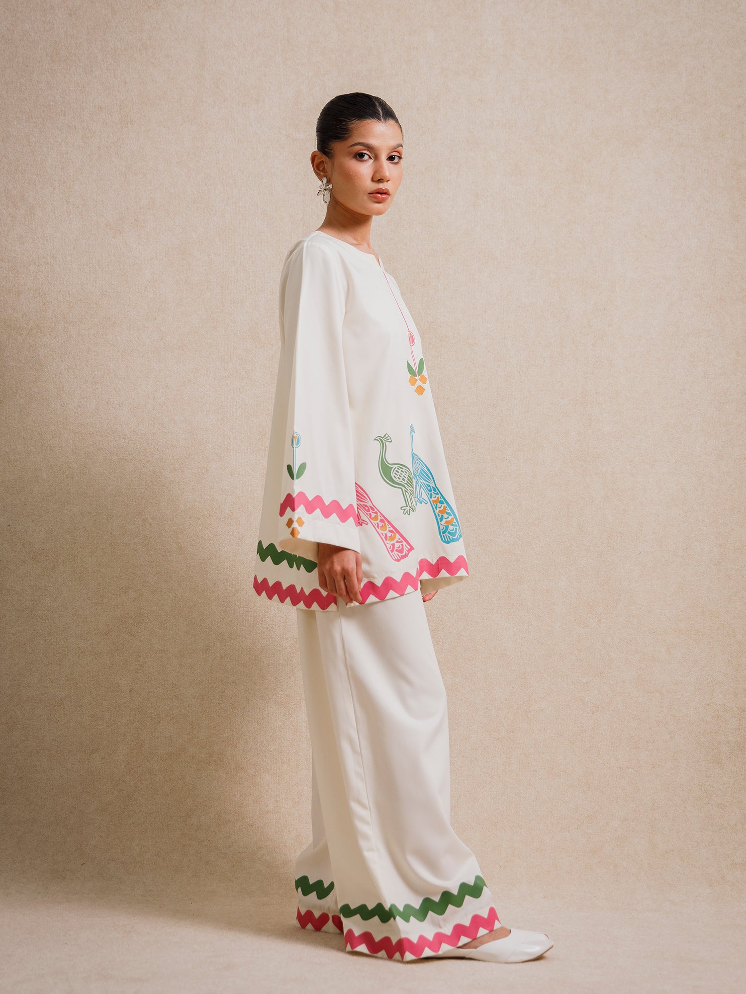 Side view of the Ivory Court two piece set with printed hem detailing on ivory fabric